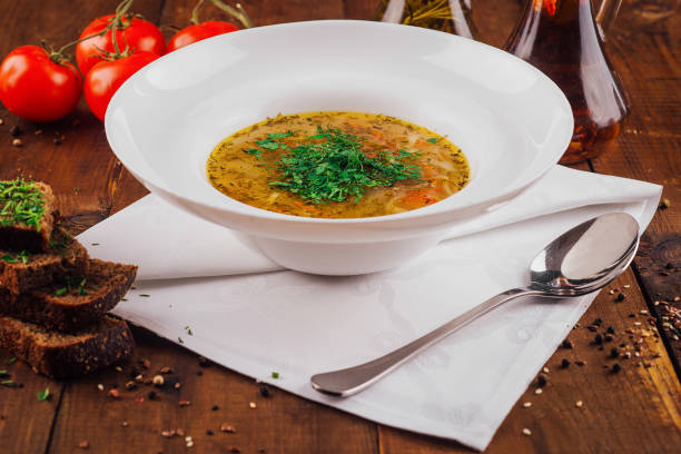 istock Delicious chicken soup with vegetables served on rustic wooden table 2172392020