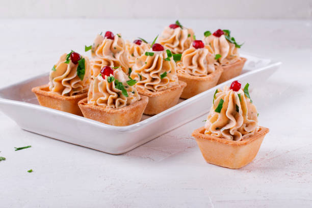 Starters with seafood pate in tartlets garnished with pomegranate seeds