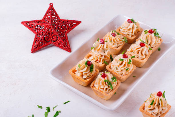 Starters with seafood pate in tartlets garnished with pomegranate seeds