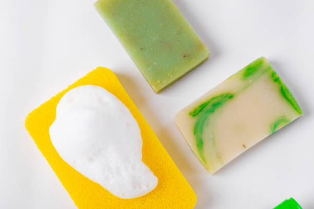bar of soap with chamomile flower on white wood table