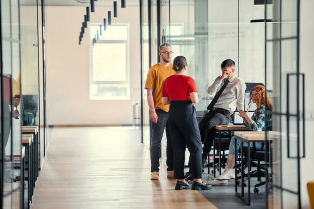 istock A dynamic group of young entrepreneurs engages in vibrant discussion within a modern glass office space, exploring new business projects and fostering innovation 2172395324