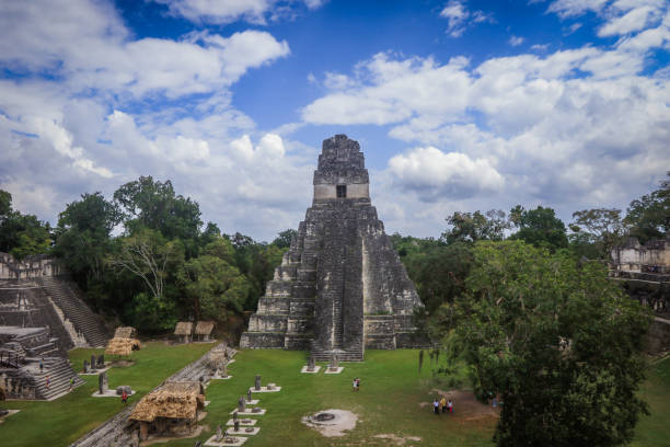istock Exploring ancient Mayan ruins of Tikal surrounded by lush greenery under a vibrant sky in Guatemala 2172395382