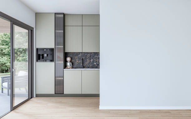 istock Modern khaki green kitchen with large windows (garden view) in the background and a white blank wall with copy space in the foreground 2172396369