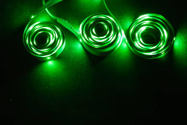 A stack of LED lights on coiled flexible lighting strips, green colors