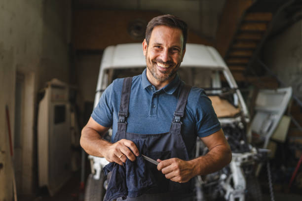 istock Car mechanic in workshop with unfinished car maintenance work 2172399134