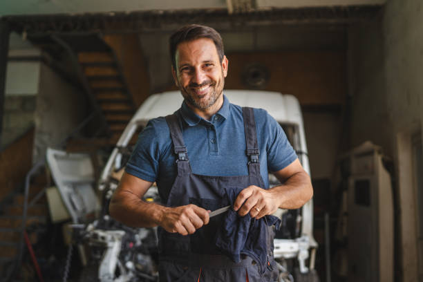 istock Car mechanic in workshop with unfinished car maintenance work 2172399363