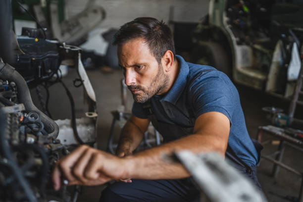 istock Car mechanic work on a car engine in a garage wearing blue shirt 2172399538