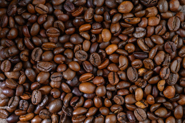 istock Roasted coffee beans on wooden background 2172405408