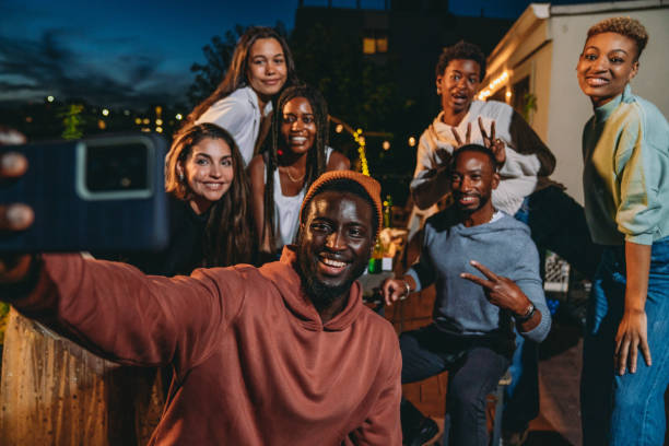 istock Multiethnic group of people are taking a selfie together during a dinner party 2172405832