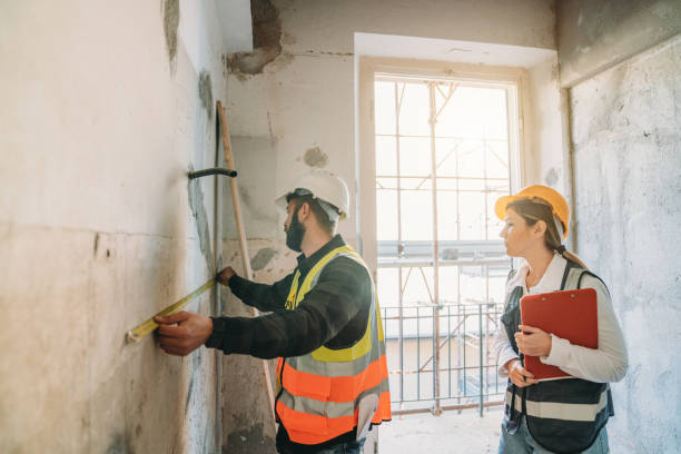 istock A man is measuring a wall at the construction site 2172406198