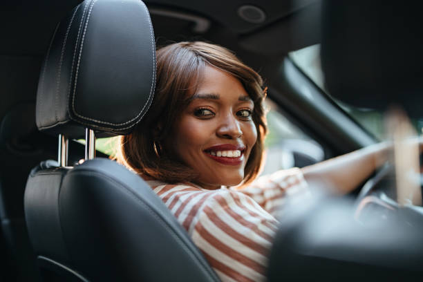 Confident Businesswoman Smiling While Driving a Car