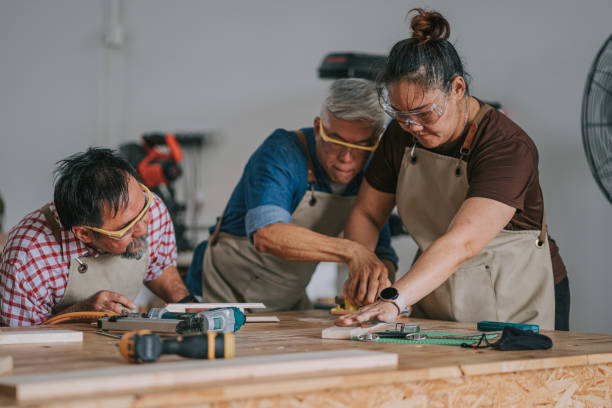 istock Asian chinese carpenter guiding adults students in woodshop workshop class 2172410122