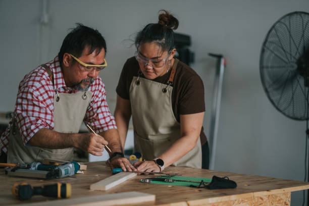 istock Asian chinese carpenter guiding adults students in woodshop workshop class 2172410131