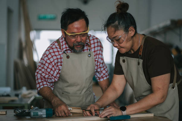 istock Asian chinese carpenter guiding adults students in woodshop workshop class 2172410139