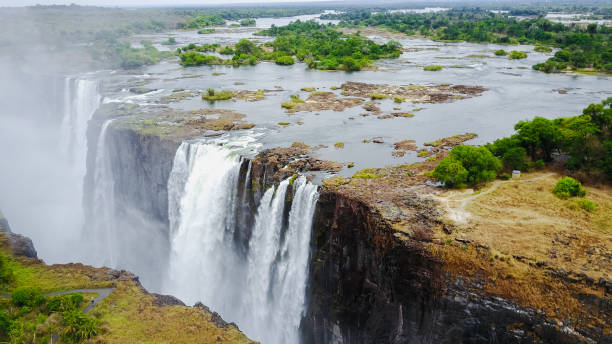istock Victoria Falls cascading dramatically over cliffs in Zimbabwe with lush greenery surrounding the water and distant landscapes at dawn 2172411071