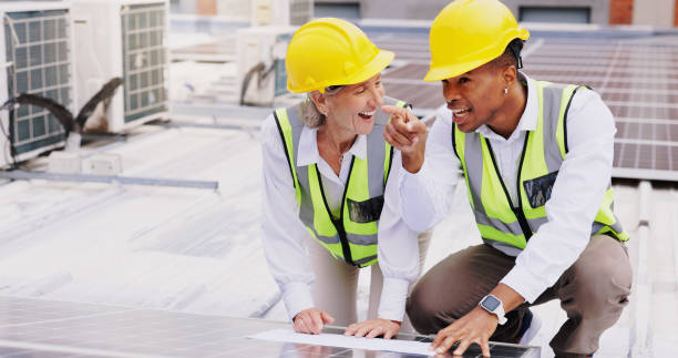 istock Solar panel, rooftop and business people with blueprint for planning, coordination or execution of project. Teamwork, engineer employees or feedback with laugh for installation, upgrade or discussion 2172411485