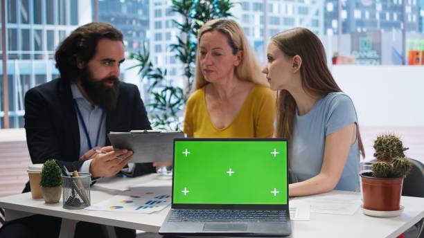 istock Financial advisor presents financial guide to clients using green screen laptop 2172412606