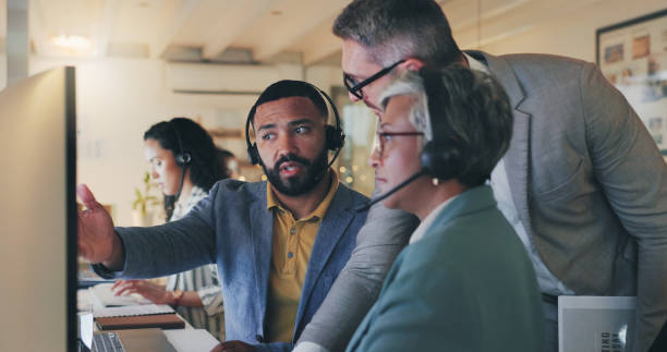 istock People, group and call center with computer, discussion and teamwork for tech support in modern office. Men, woman and diversity in workplace by pc for review, problem solving and solution at night 2172414479