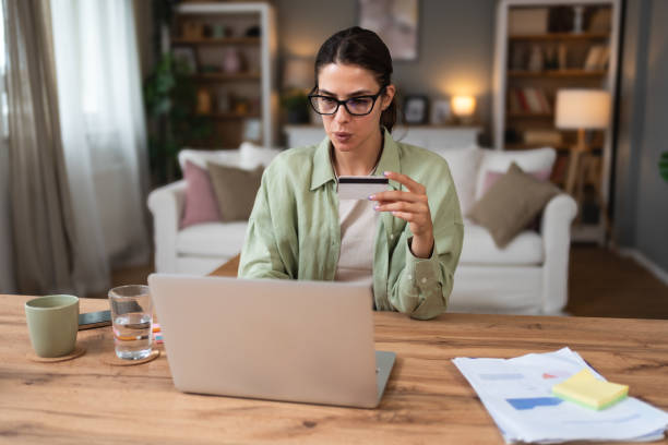 istock Confused young woman having problem with blocked credit card making rejected unsecure online payment using laptop at home, invalid expired account, transaction failed, money withdraw impossible, debt 2172415256