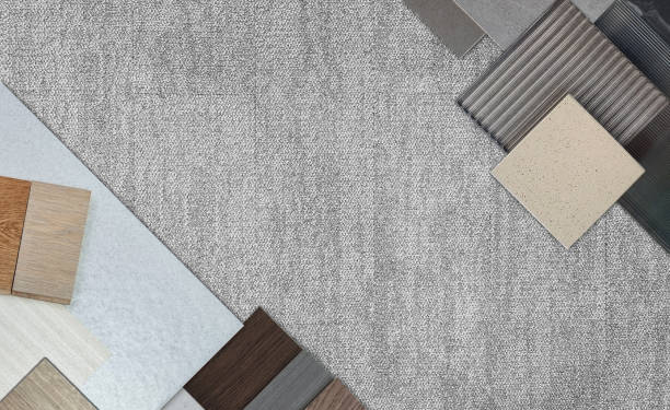 istock top view of interior material samples board contains ash vinyl flooring tile, stone ceramic tiles, interior fabric wallpapers, wooden laminated flooring placed on grey fabric carpet floor. 2172416608