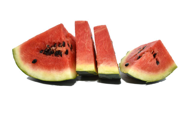 Ripe red watermelon cut into slices lying on a white background.