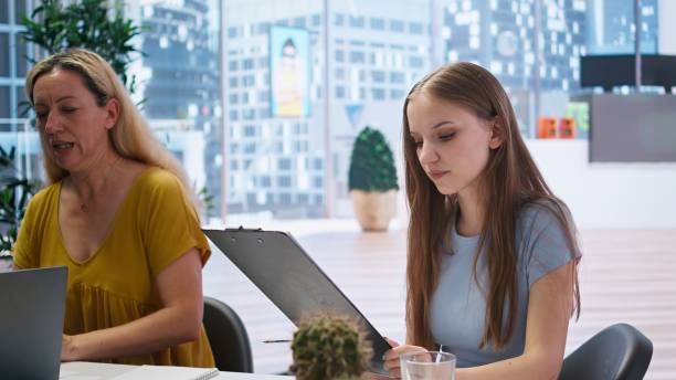 istock Young adult reading personalized financial plan given by financial advisor 2172420831