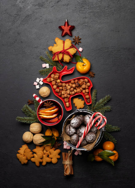 istock Christmas tree-shaped with cookies, surrounded by assorted nuts and festive decor 2172422464