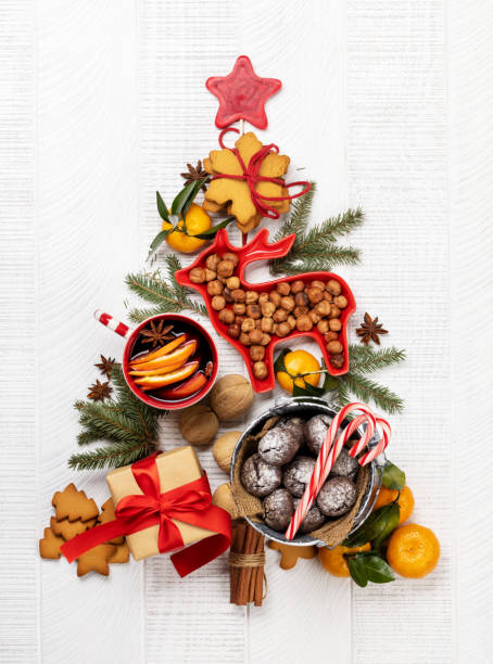 Christmas tree-shaped with cookies, surrounded by assorted nuts and festive decor