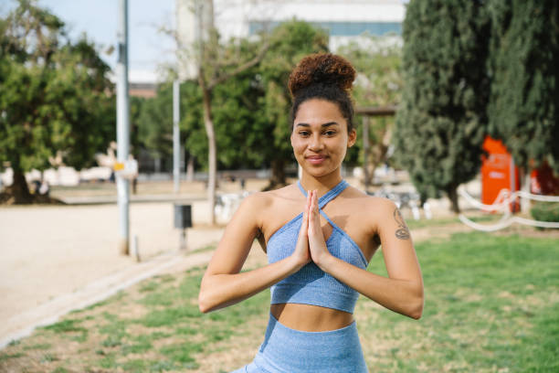istock Woman in Blue Activewear Practicing Yoga in Park 2172425039