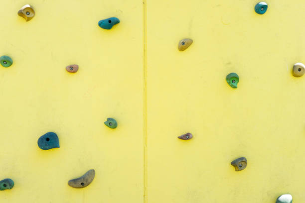 istock Climbing wall with varied handholds. 2172426104