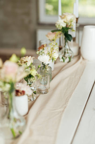 istock Elegant neutral coloured wedding table scape with flowers and candles 2172426243