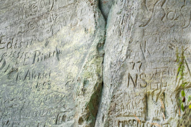 istock Carvings and Graffiti Etched Into Weathered Rock 2172433090