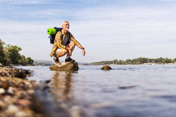 Senior Man Hiking Along a River