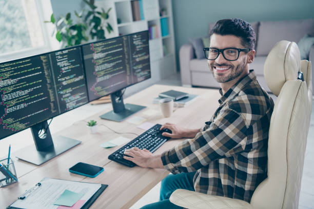 istock Photo of happy cheerful coder dressed eyewear writing keyboard web designing indoors workplace workstation loft 2172437178