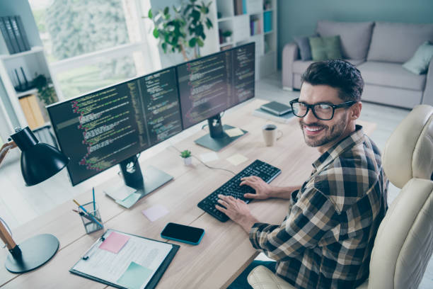 istock Photo of cheerful positive freelancer wear eyeglasses programming modern gadget application indoors workplace workstation loft 2172437184
