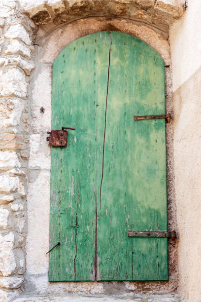 Old wooden door on a stone wall.