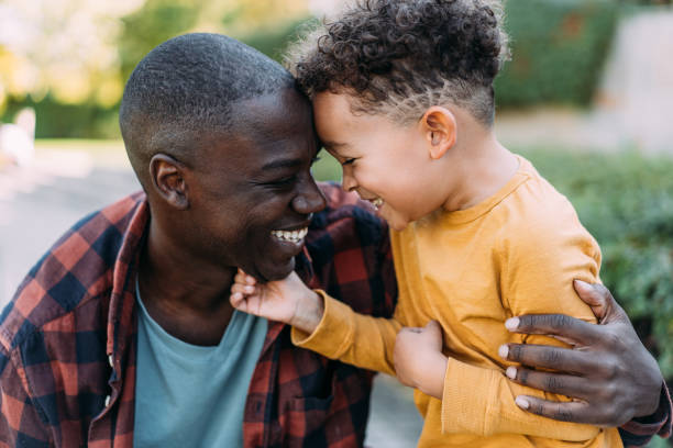 istock Father and son hugging each other while playing outdoors. 2172438770