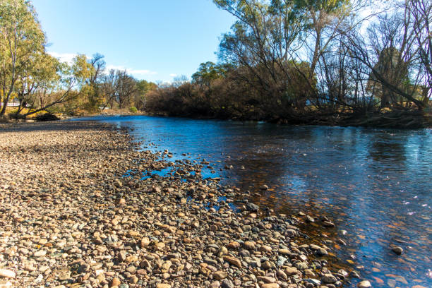 Photograph of the Tumut River flowing peacefully through the regional township of Tumut in the picturesque Snowy Mountains in New South Wales, Australia.