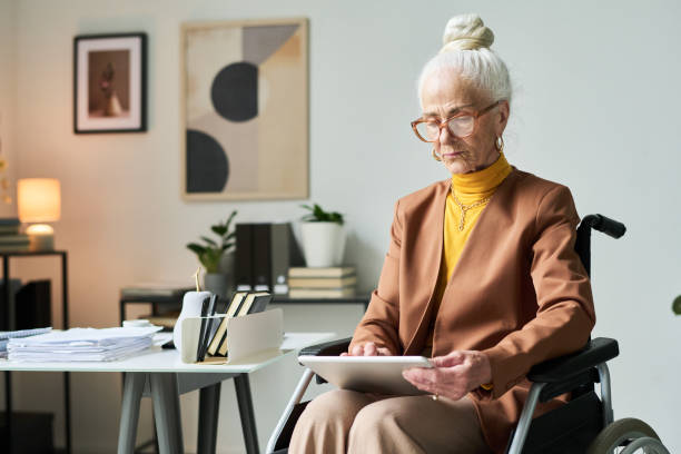 istock Senior Woman Working in Modern Office with Tablet 2172447810