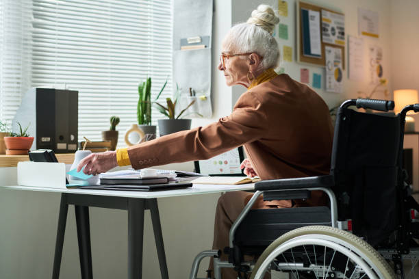 istock Elderly Person Working at Desk in Modern Office Setting 2172447812