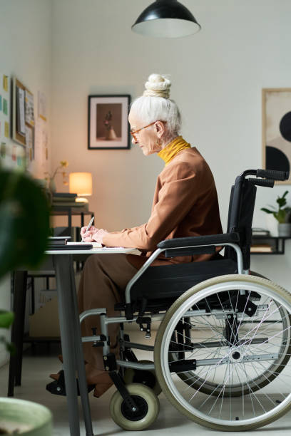 istock Senior Woman Writing Notes at Home Office Desk 2172447824