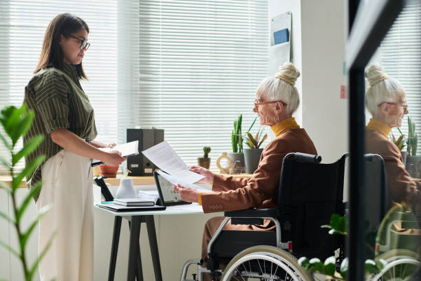 istock Assisting Elderly Woman with Office Paperwork 2172447830