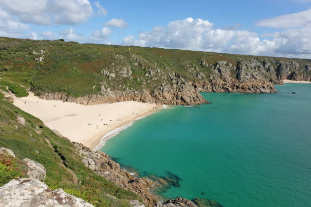 istock Sandy Porthcurno Beach, with Logan Rock headland, West Cornwall, UK. 2172448362