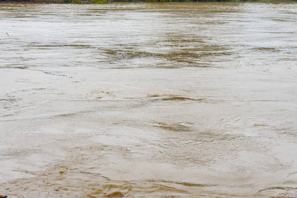Water flows in the river during flooding after heavy rains.