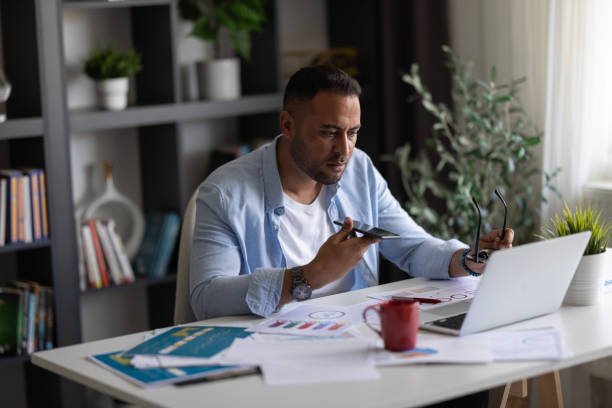 istock Busy freelance professional man talking on mobile phone on speaker 2172451583