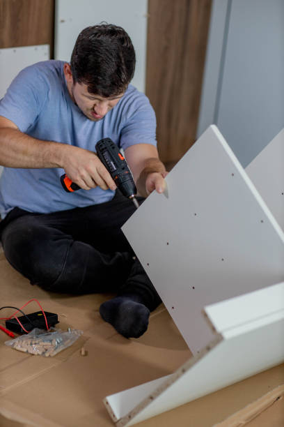 istock Man assembling furniture by using cordless screwdriver 2172458853