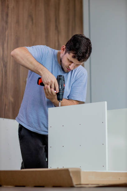istock Man assembling furniture by using cordless screwdriver 2172458854