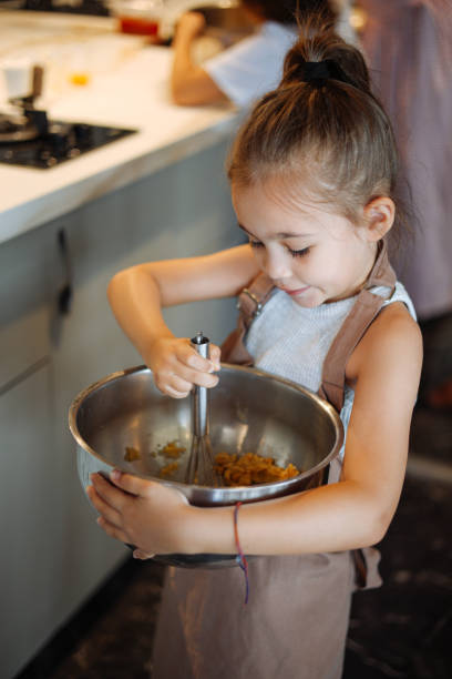 istock Cute little girl at cookie making course 2172459032