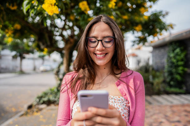 istock Young woman using mobile phone outdoors 2172461739