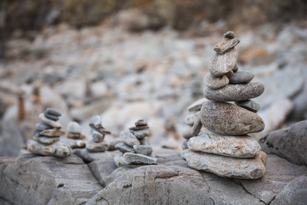 istock serene beach scene with smooth rocks stacked in a balanced formation. The tranquil atmosphere evokes a sense of zen, harmony, and peace, symbolizing balance and mindfulness in nature 2172463010